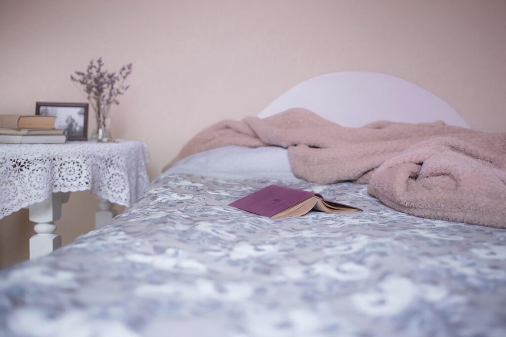 Picture of bed with a book in it
source: https://pixabay.com/photos/bed-bedroom-blanket-books-cover-1846251/