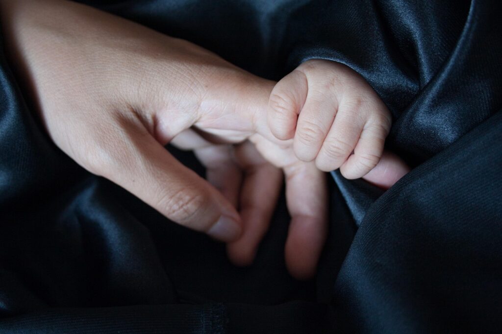 mom's finger being held by baby's hand
source: https://pixabay.com/photos/touch-holding-hands-affection-2579147/